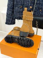 Tan high-top boot with treaded rubber outsole and gold studded trim