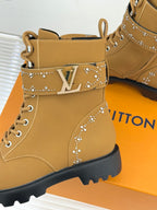 Tan high-top boot with LV monogram plate, studded trim, and lace-up front