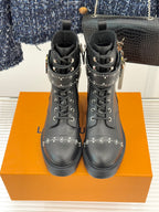 Louis Vuitton black studded ankle boots facing front, lace-up