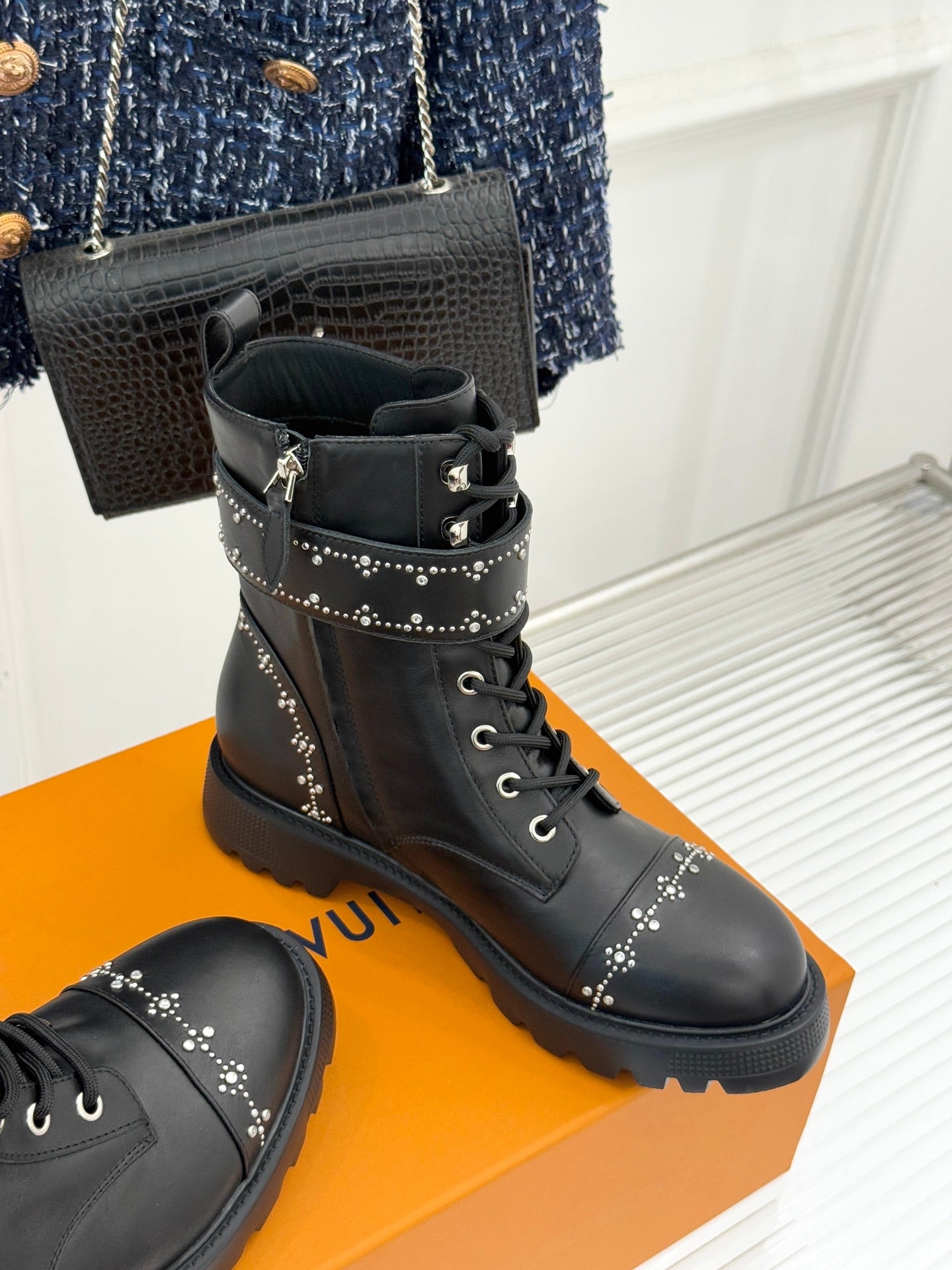 Louis Vuitton black studded ankle boots on a box with lace ties