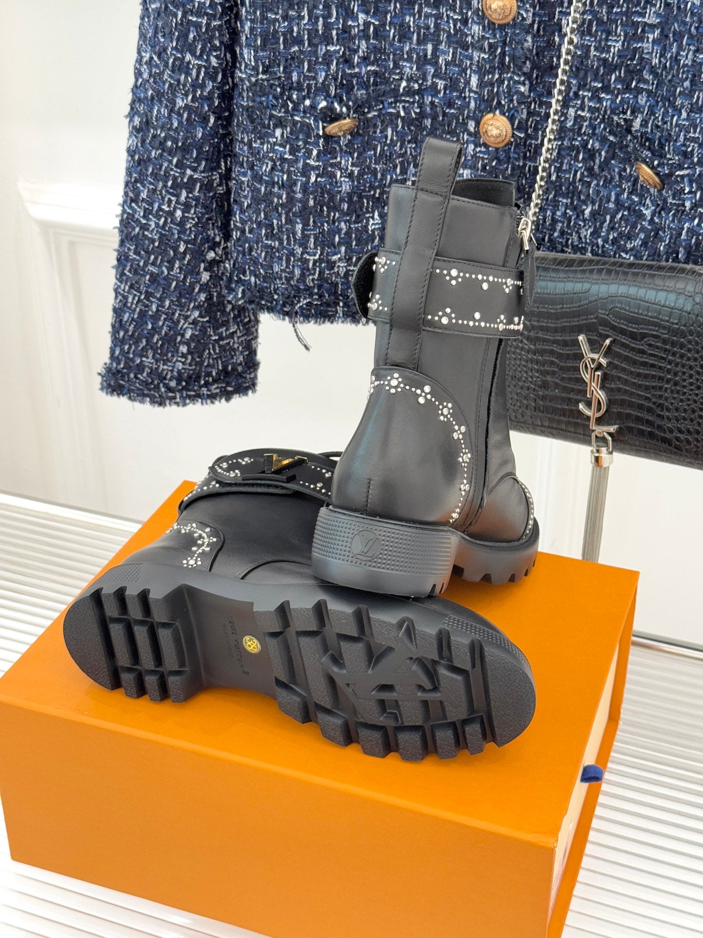Louis Vuitton black boot outsoles and heels on orange box