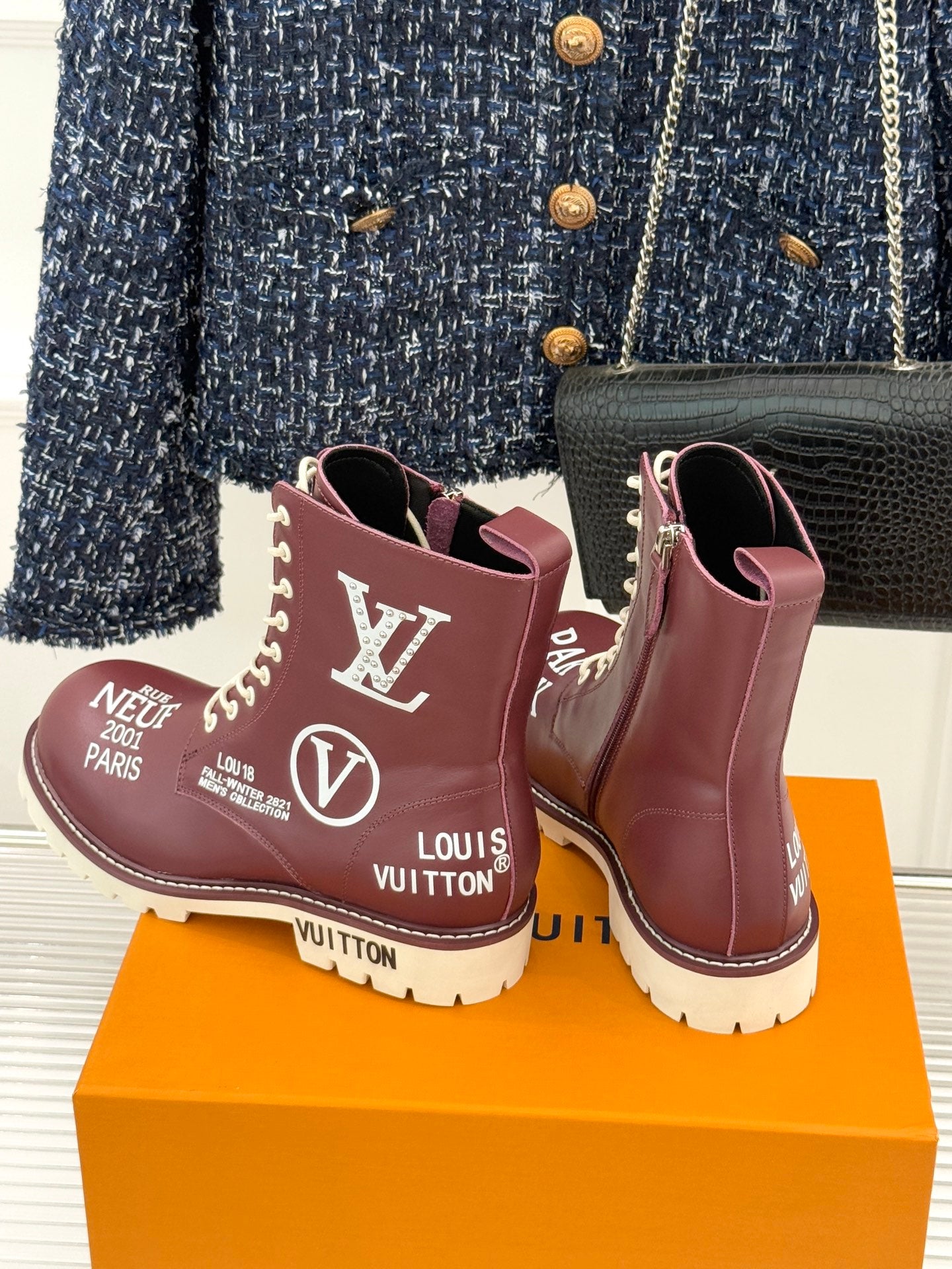 Burgundy Louis Vuitton lace-up ankle boots with LV and V emblems, white tread sole
