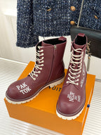 Burgundy Louis Vuitton lace-up ankle boots with gold eyelets and side logo patches, white sole