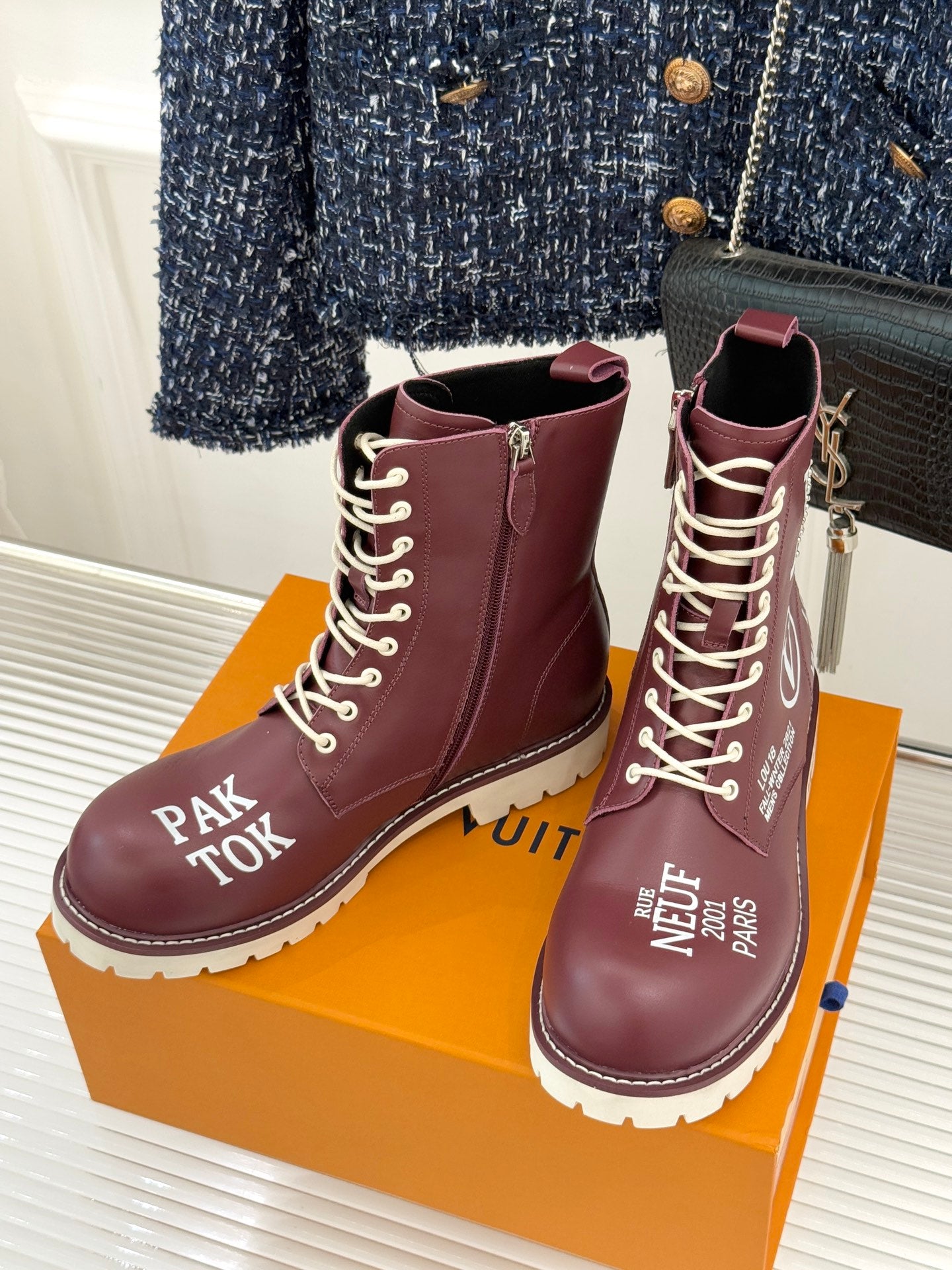 Burgundy Louis Vuitton lace-up ankle boots with gold eyelets and side logo patches, white sole