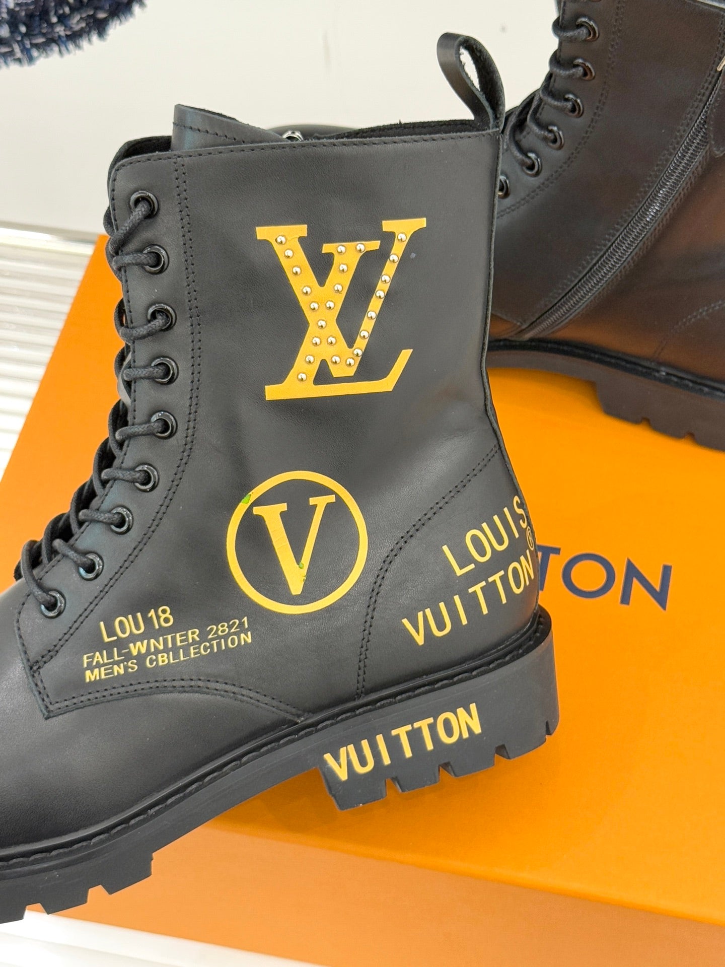 Louis Vuitton ladies lace-up ankle boots close-up, black leather, large LV and V logos