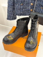 Louis Vuitton ladies lace-up ankle boots, dark leather, front logo text, lug sole