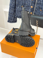 Louis Vuitton ladies lace-up ankle boots, black leather, treaded outsole and heel view