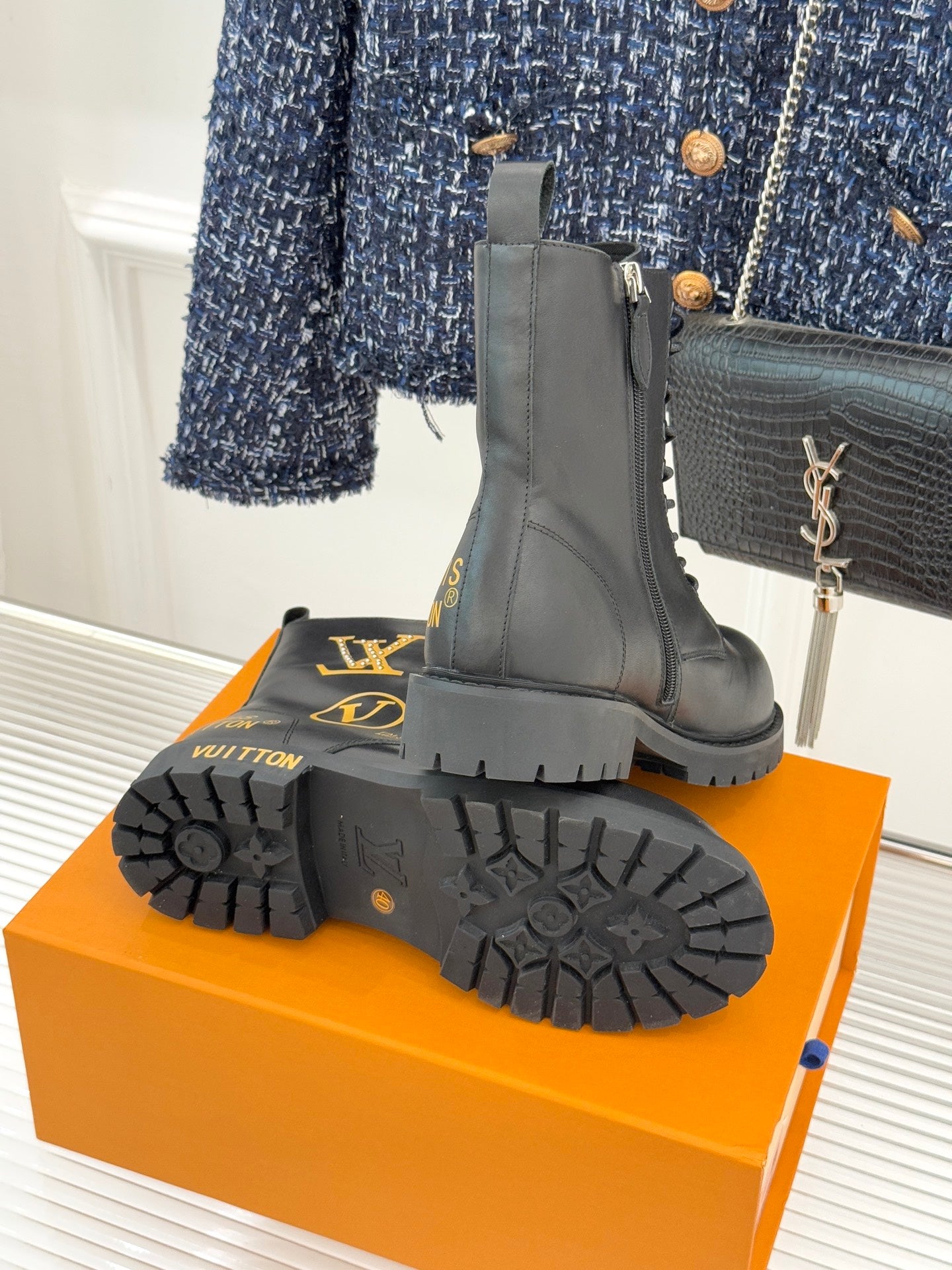 Louis Vuitton ladies lace-up ankle boots, black leather, treaded outsole and heel view