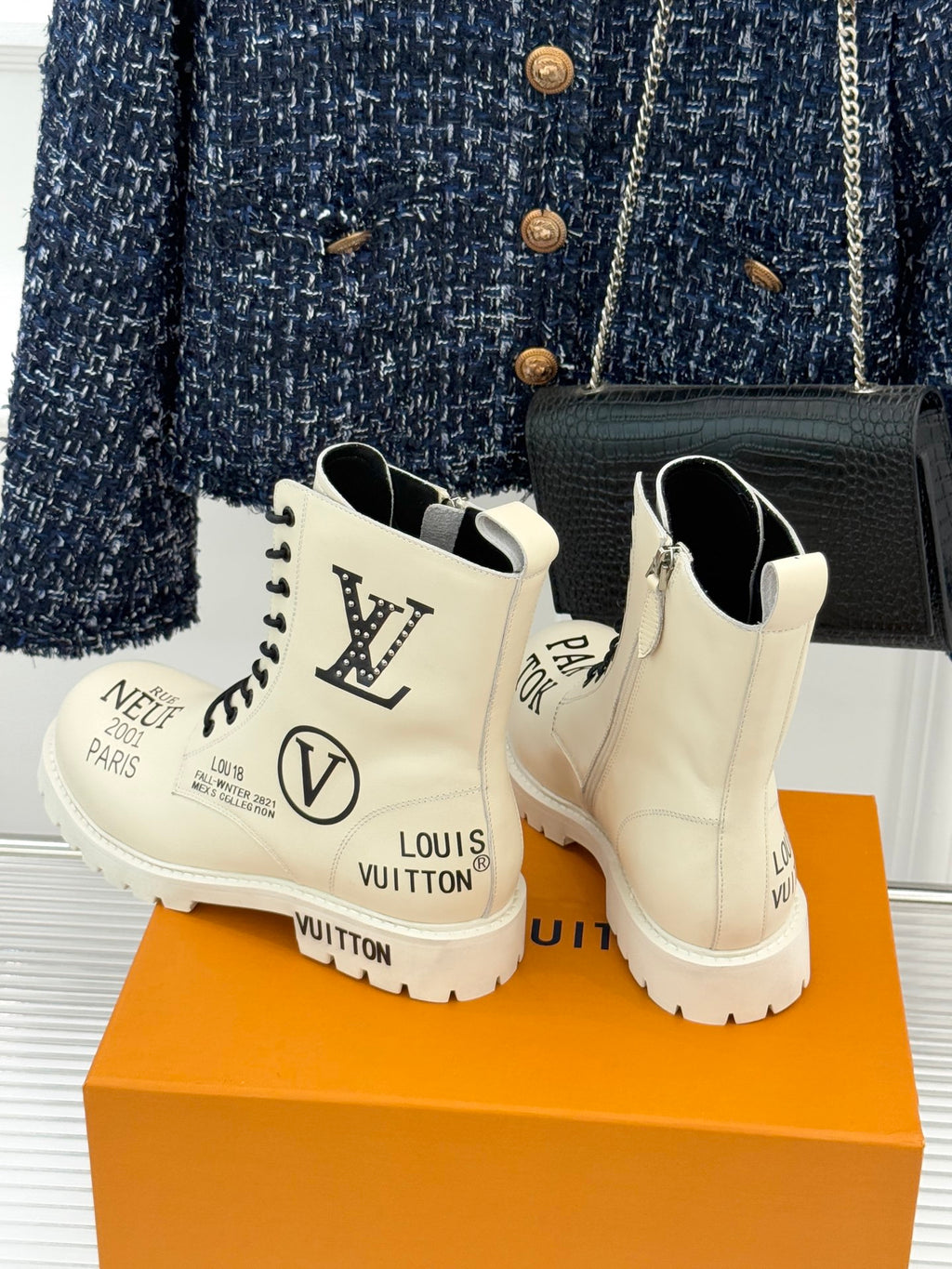 Cream Louis Vuitton ankle boots with black laces, monogram heel back and chunky sole