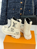 Cream Louis Vuitton ankle boots with black laces, monogram heel back and chunky sole