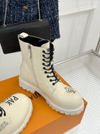Cream leather lace-up ankle boot with black laces and logo detail on side