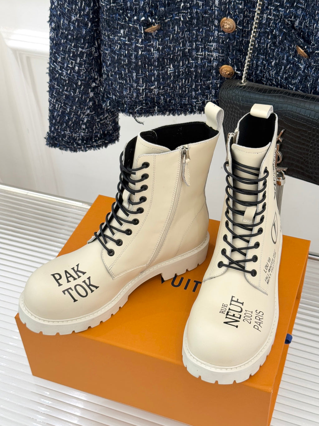 Louis Vuitton ladies ankle boots pair, cream leather, black lace-up front and rugged sole