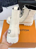Cream leather ankle boots back view, black laces, zip detail, and thick tread sole