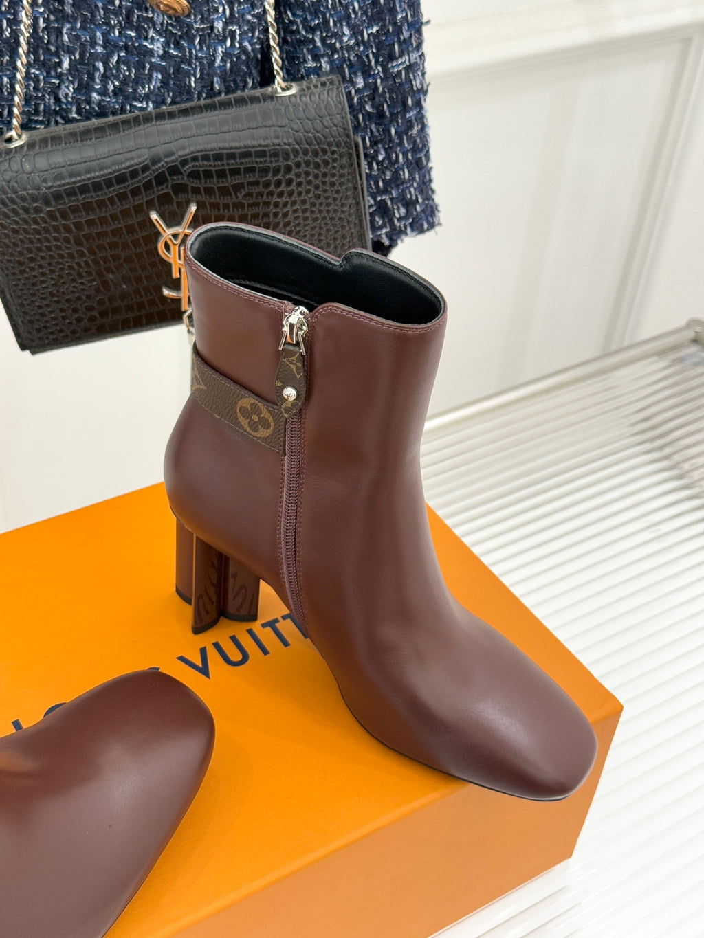 Brown ankle boots with square buckle strap and side zipper on block heel