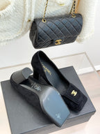 Black suede heeled loafers with gold CC emblem and CHANEL logo on lining