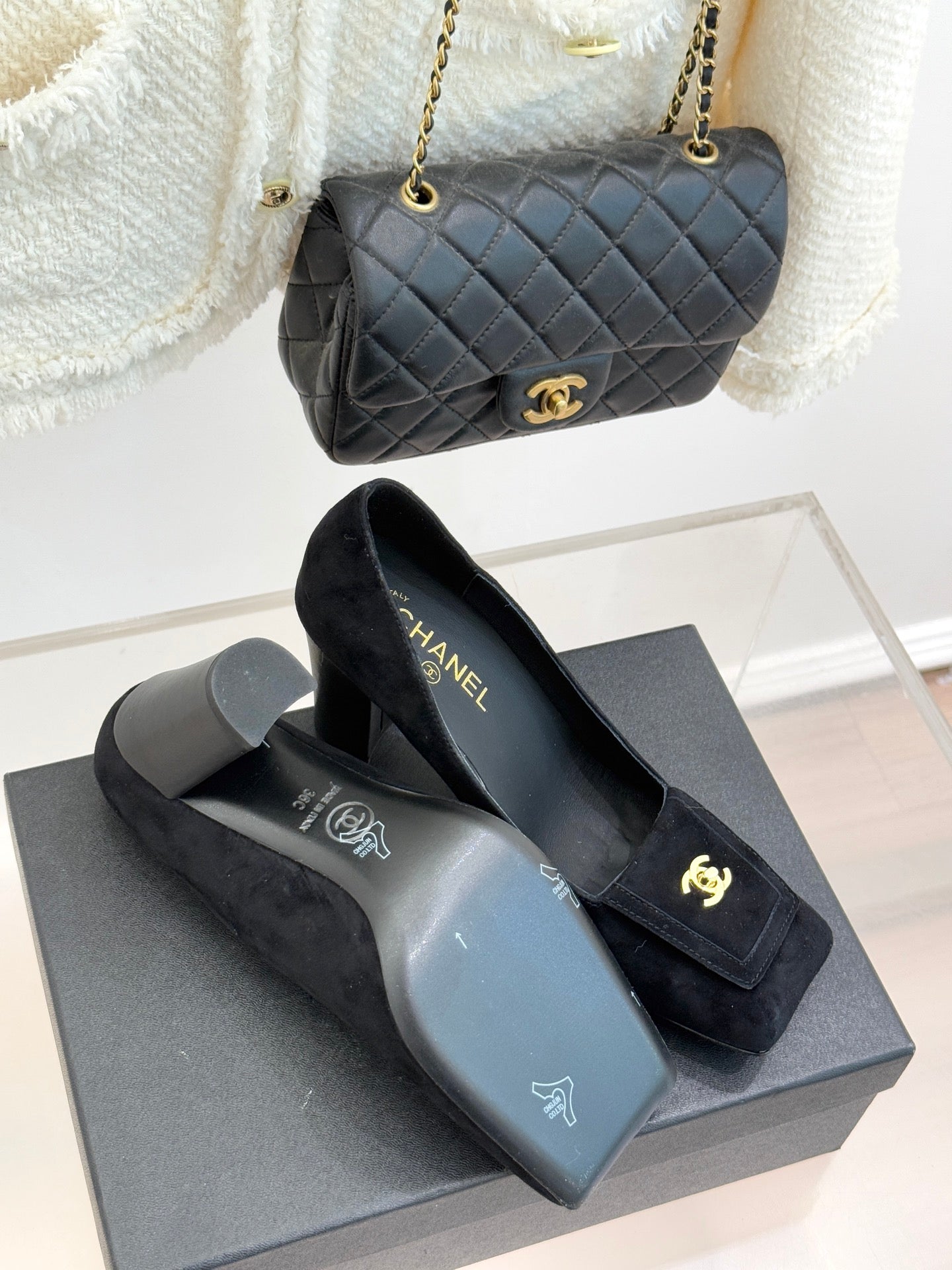 Black suede heeled loafers with gold CC emblem and CHANEL logo on lining