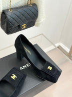 Black suede heeled loafers with gold CC emblem and slip-on profile