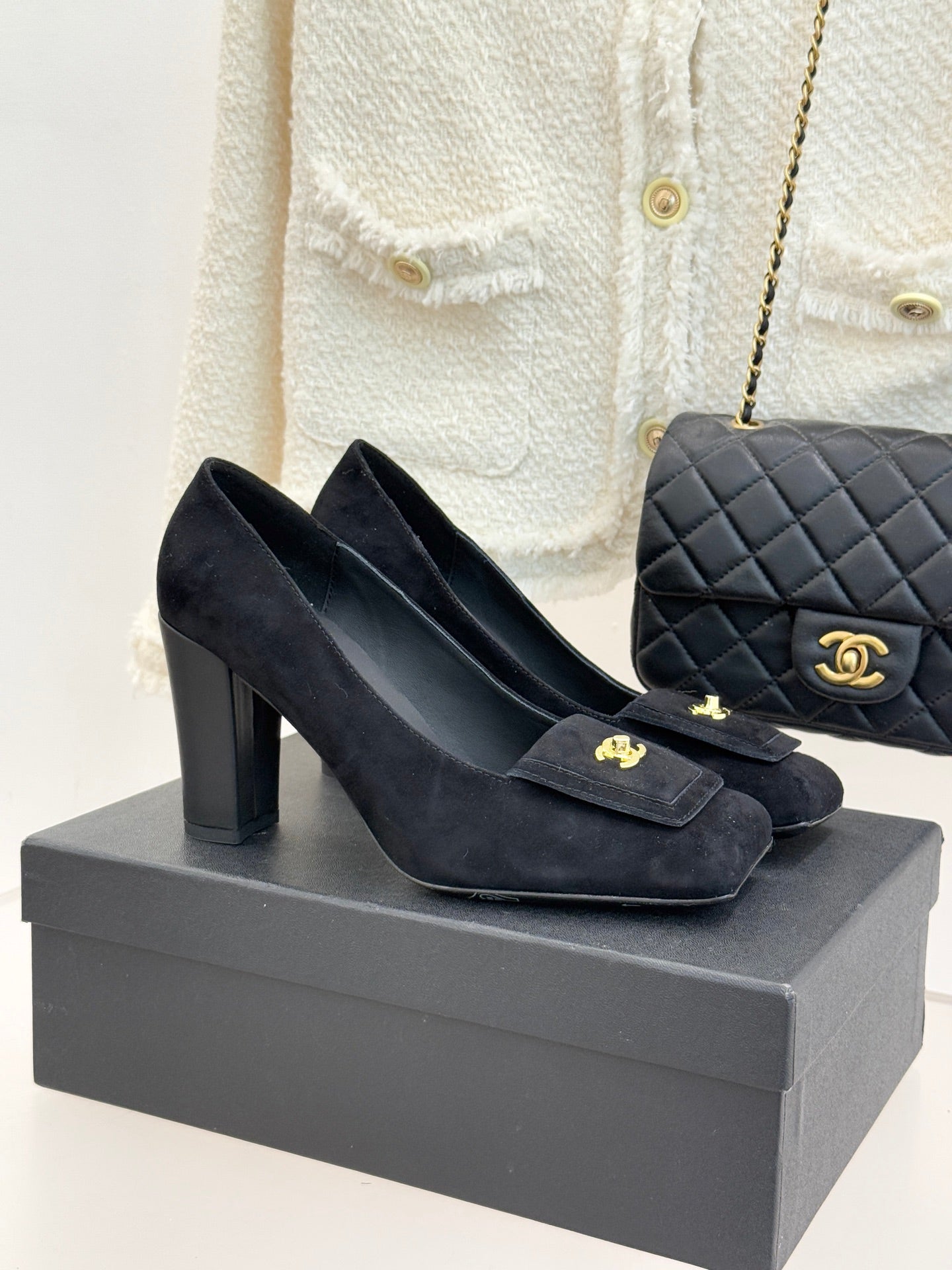Black suede heeled loafers with gold CC emblem and front buckle