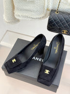 Black suede loafers with gold CC emblem, slip-on design and block heel
