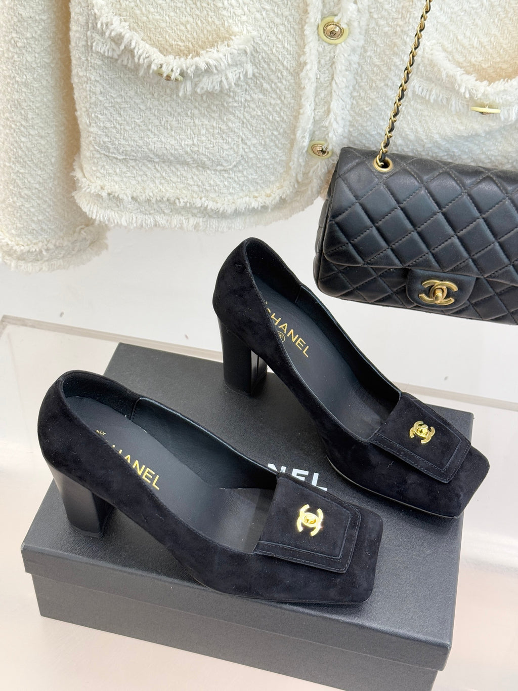 Black suede heeled loafers with gold CC emblem and front buckle detail