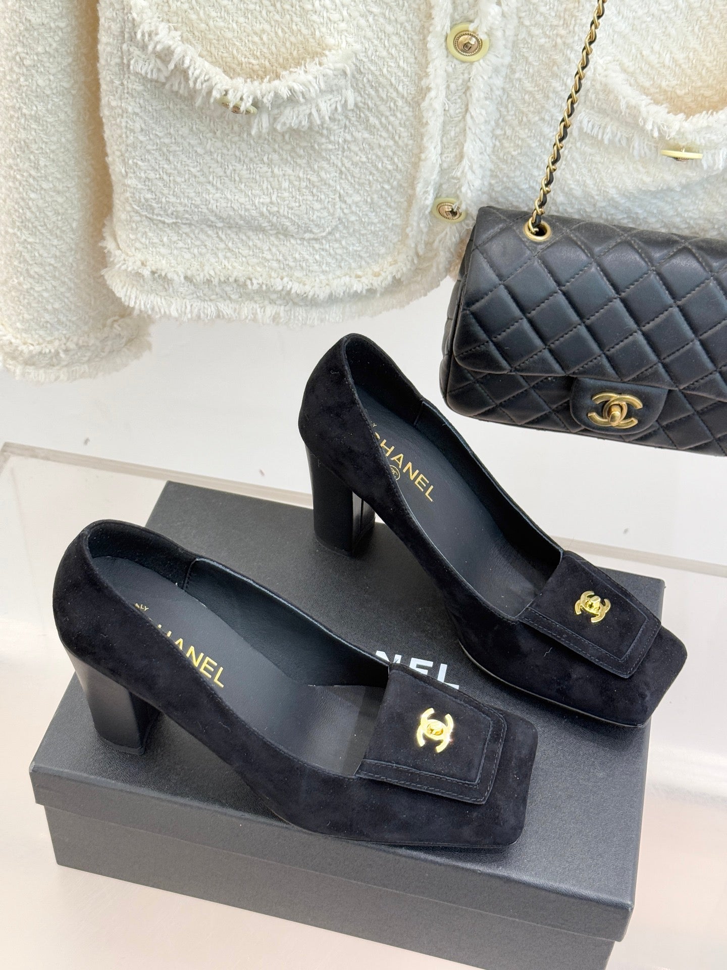 Black suede heeled loafers with gold CC emblem and front buckle detail