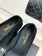 Black suede loafers with CHANEL logo on insole and gold CC emblem
