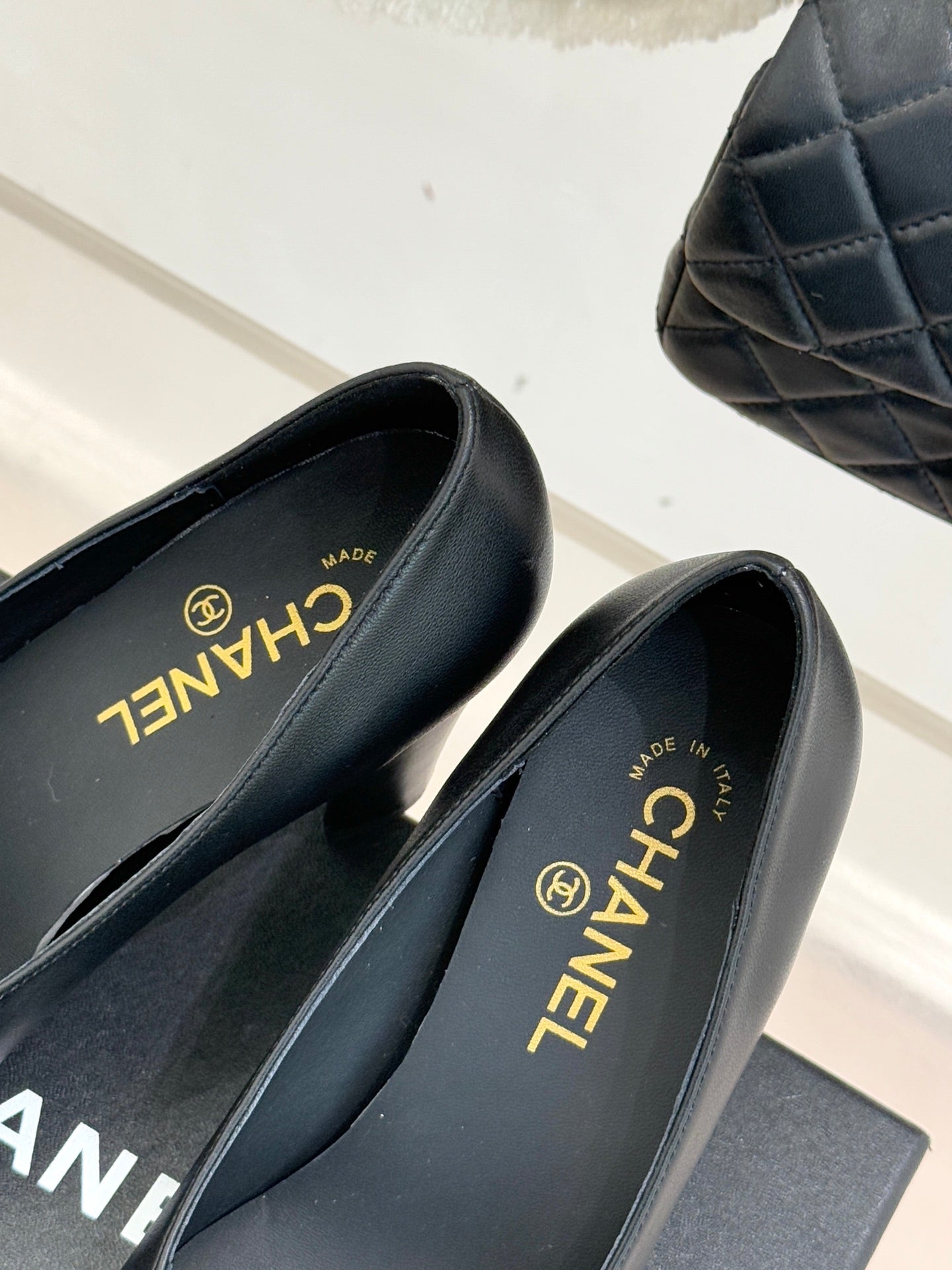 Black heeled mules close-up of CHANEL logo on insole