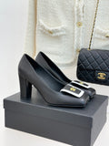 Black Chanel ladies heeled mules with white-trim buckle and gold emblem