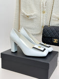 White leather block-heel pumps with black-trimmed square toe and gold logo detail