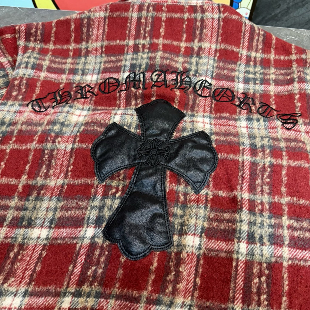 Red plaid coat with black faux-leather cross applique on front
