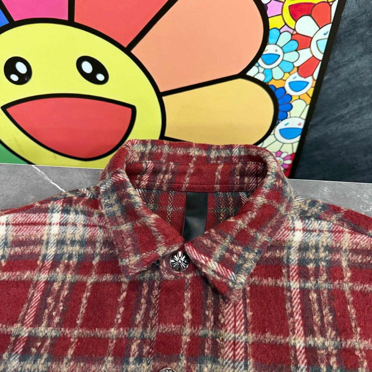 Red plaid long-sleeve coat with buttoned collar and decorative buttons