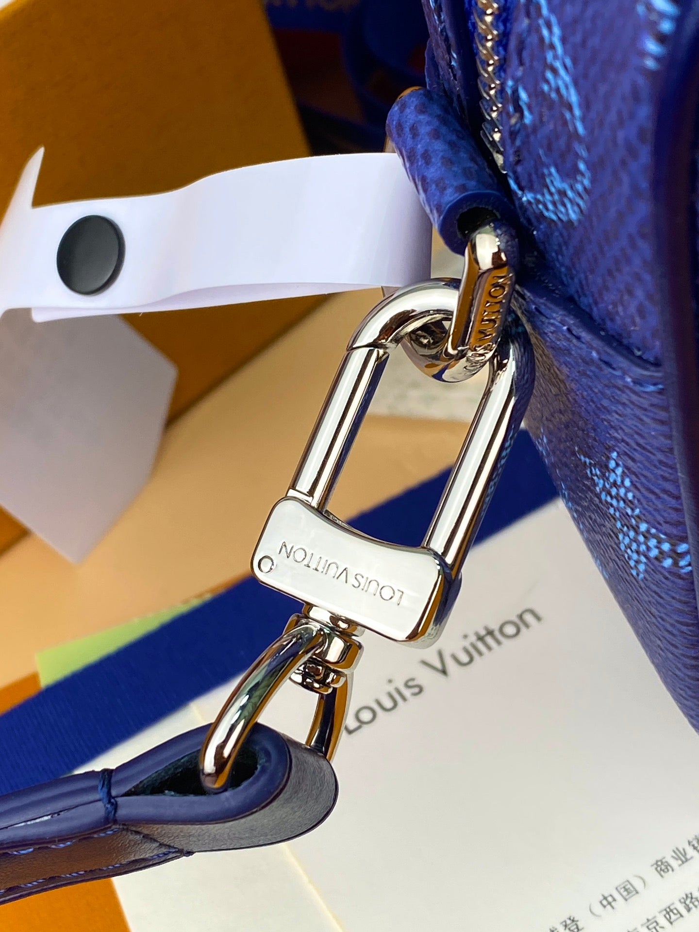 Men's Louis Vuitton bag hardware clasp with blue leather strap and metal ring