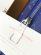 Men's Louis Vuitton bag zipper close-up with metal pull on blue strap