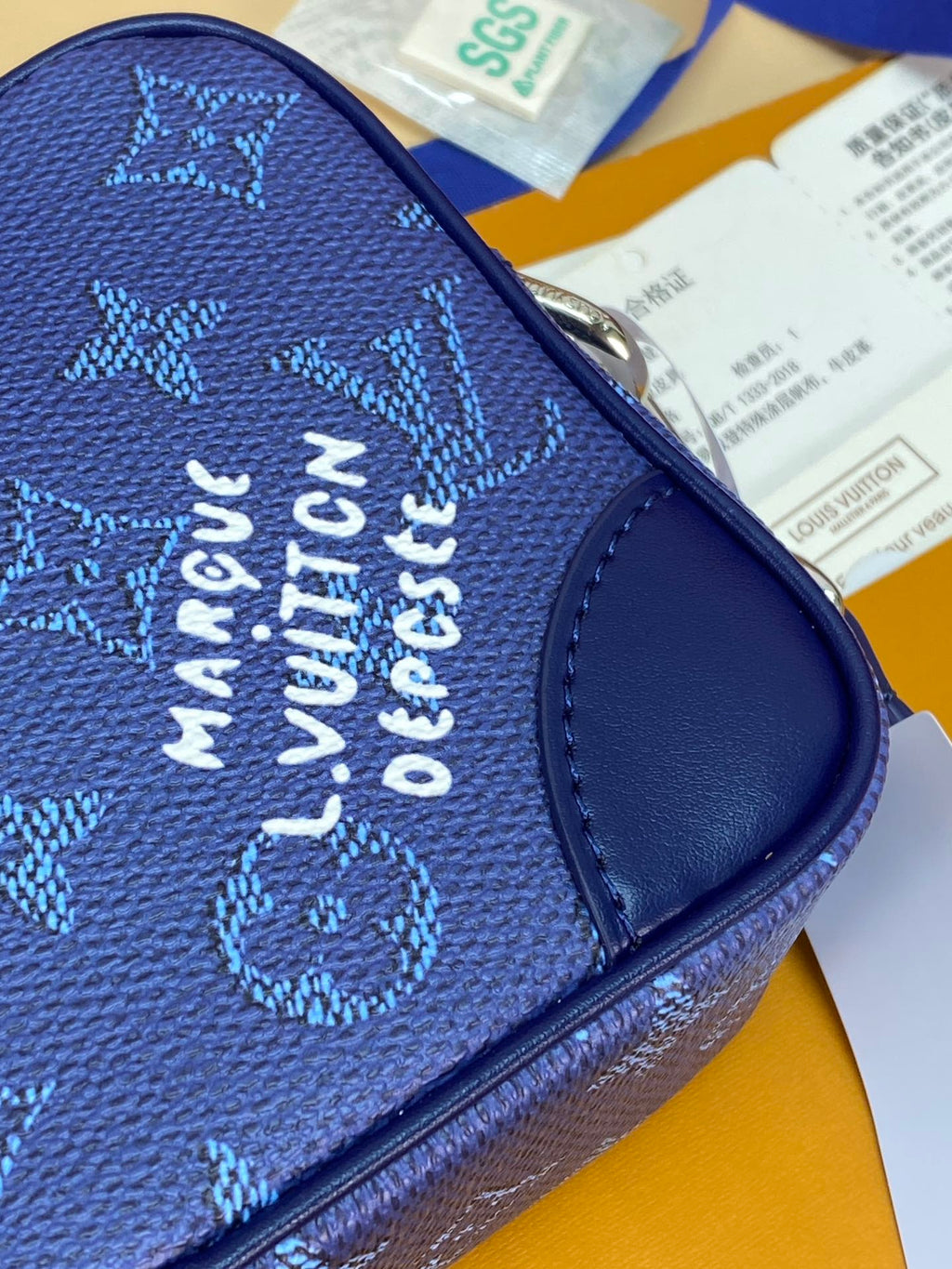 Men's Louis Vuitton bag blue monogram exterior with metal zipper and embossed text