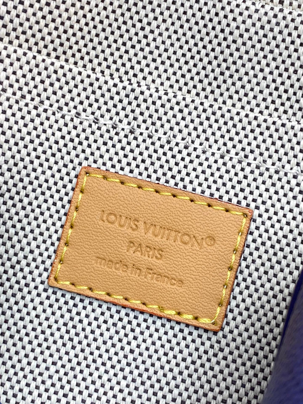 Louis Vuitton Paris leather label on blue textured monogram crossbody bag