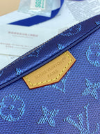 Blue monogram crossbody bag with gold-toned logo plaque on front