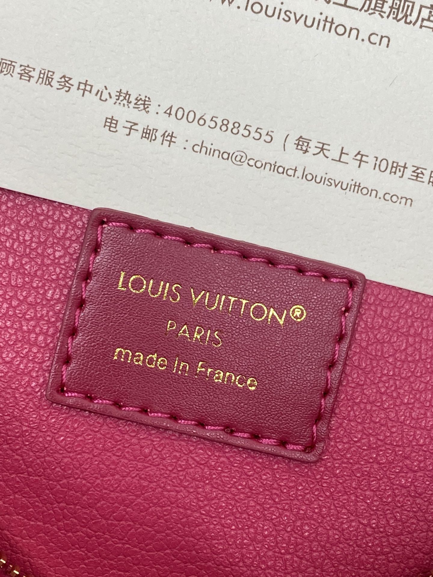 Louis Vuitton Paris made in France leather label on magenta zip pouch