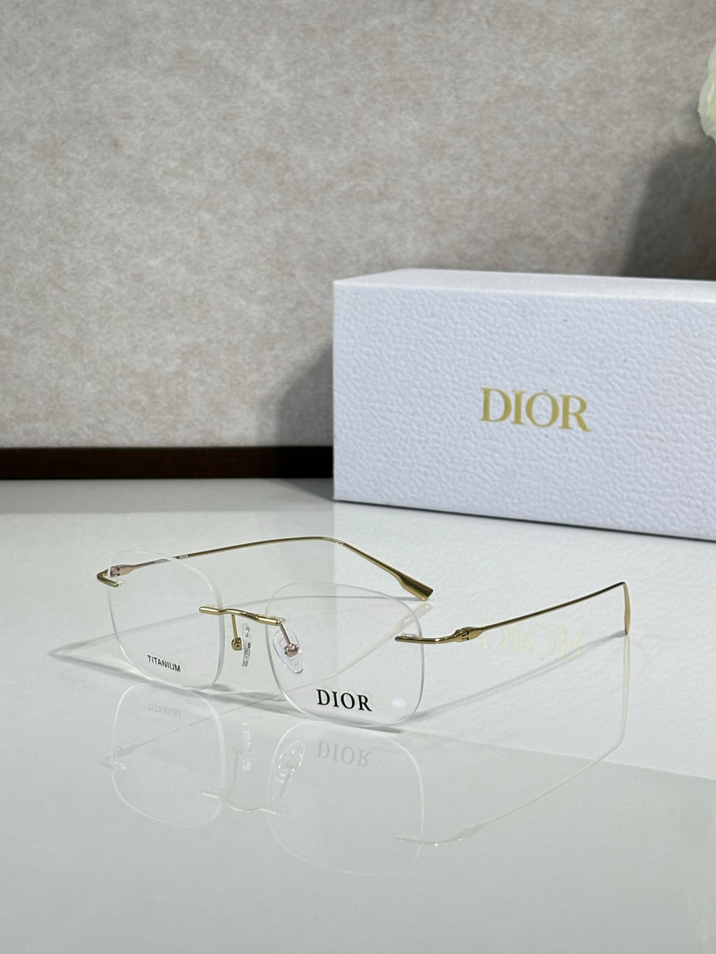 Dior eyeglasses, side profile with gold-tone frame and clear temples