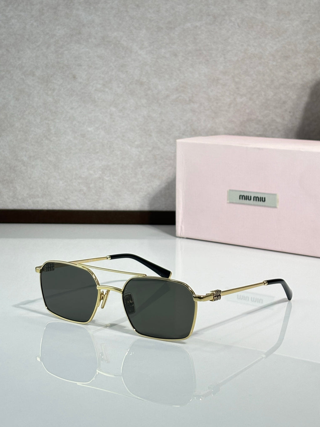 MiuMiu sunglasses, gold metal with dark green lenses and black temple tips