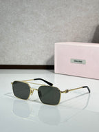 MiuMiu sunglasses, gold metal with dark green lenses and black temple tips