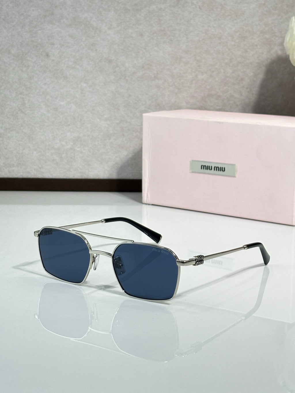 MiuMiu sunglasses, silver metal with dark blue lenses and clear temple arms