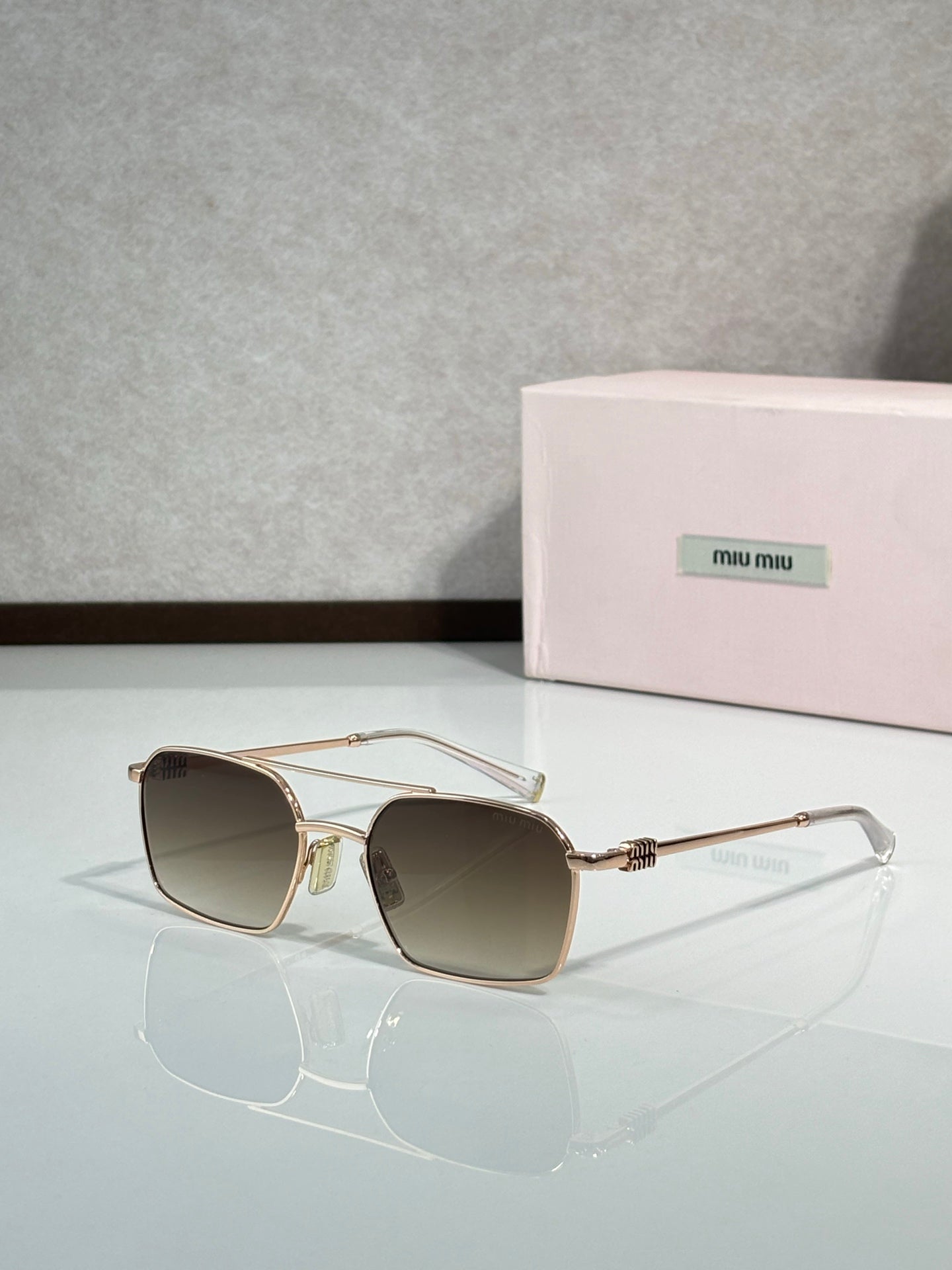 MiuMiu sunglasses, gold metal with brown lenses and clear temple arms