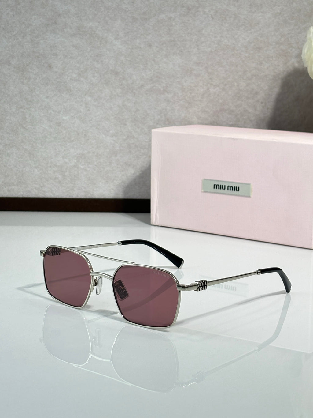 MiuMiu sunglasses, silver metal with rose-tinted lenses and black temple arms