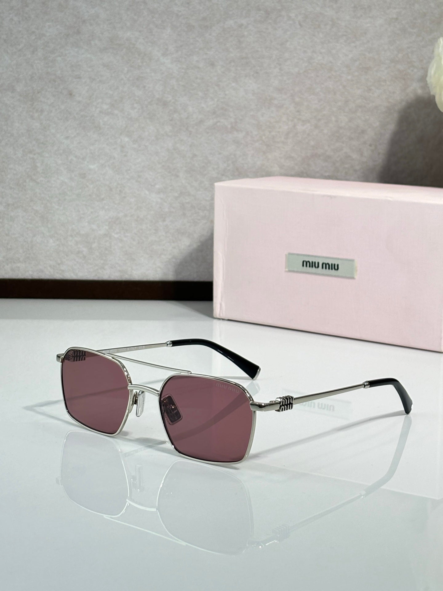 MiuMiu sunglasses, silver metal with rose-tinted lenses and black temple arms