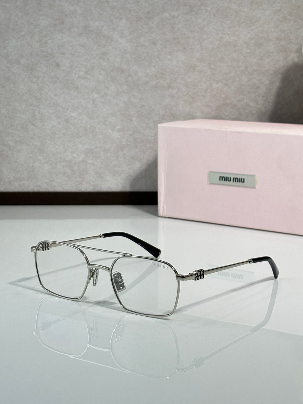 Silver-tone rectangular eyeglasses with clear lenses and metal temples