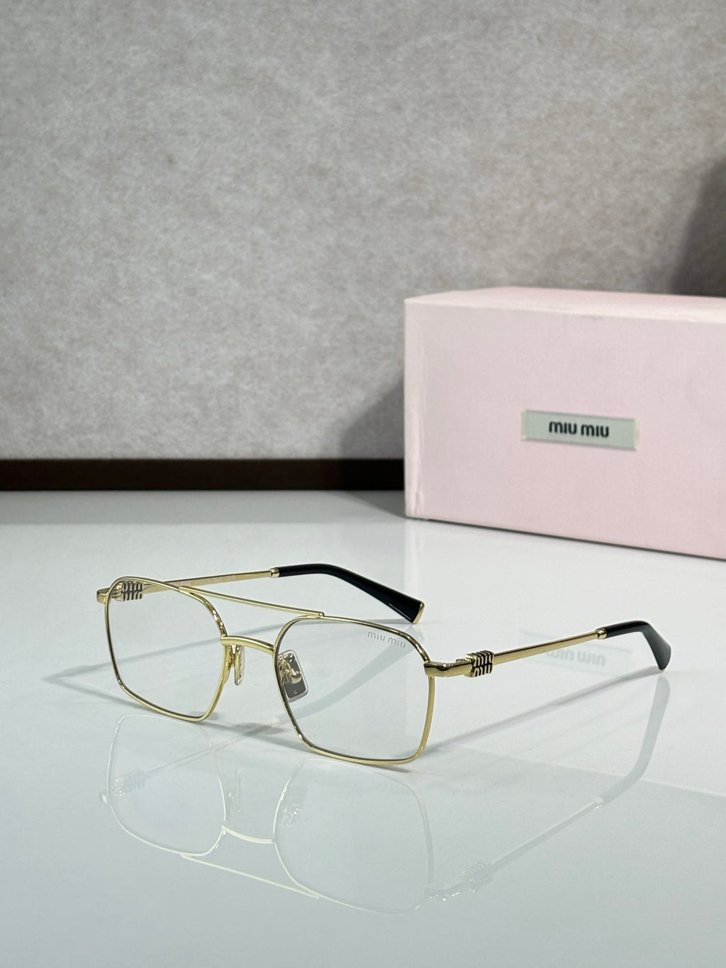 Gold-tone rectangular eyeglasses with clear lenses and metal temples