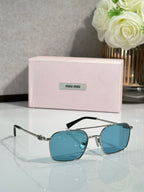 Gold-tone rectangular sunglasses with blue lenses and black top bar