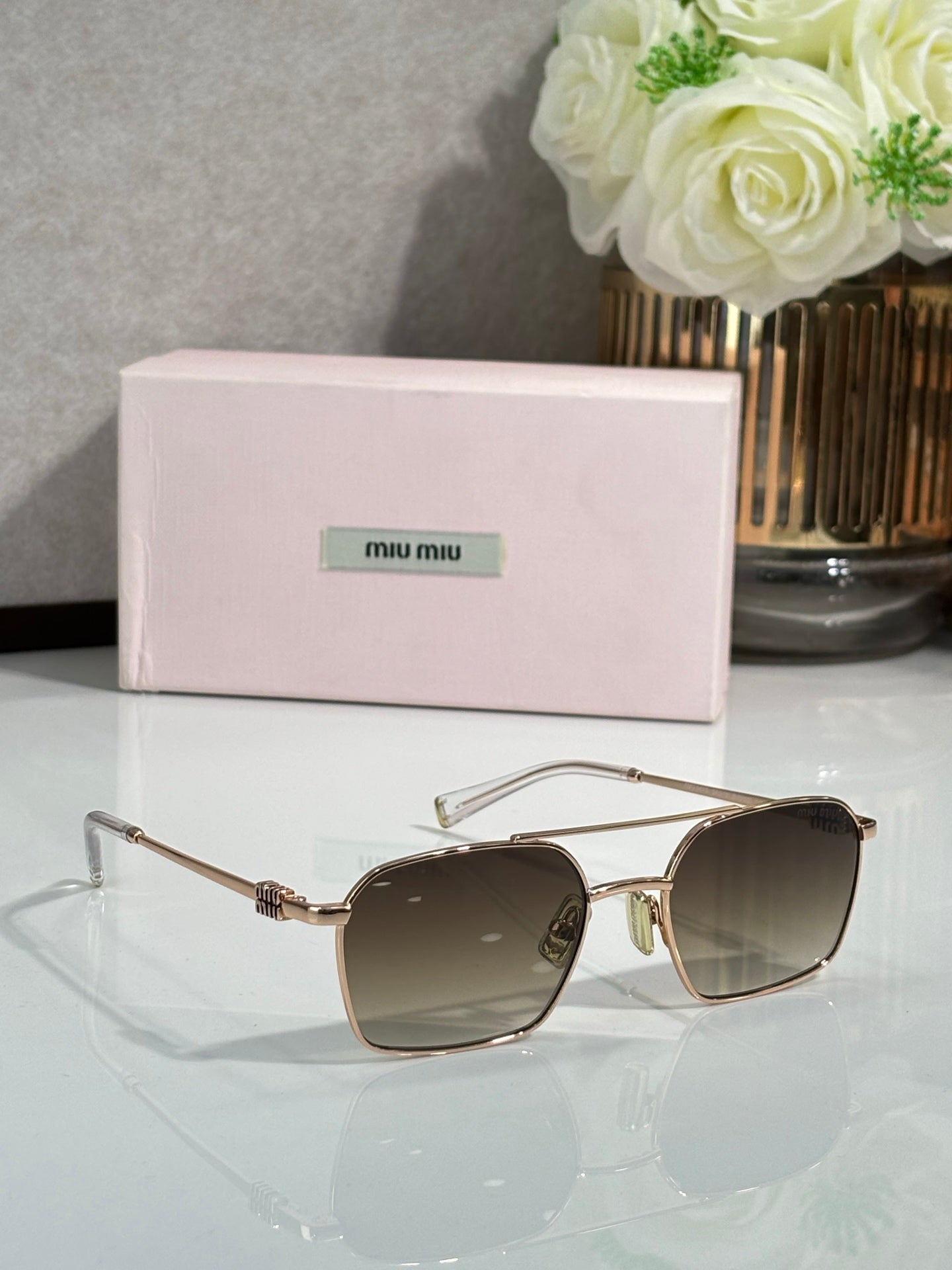 Gold-tone rectangular sunglasses with dark brown lenses and metal temples