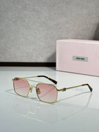 Gold-tone rectangular eyeglasses with pink-tinted lenses and decorative hinges