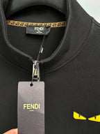 Fendi black zip-up sweatshirt neck label with dangling tag and yellow logo